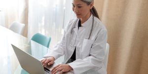 Medical specialist working on laptop at office